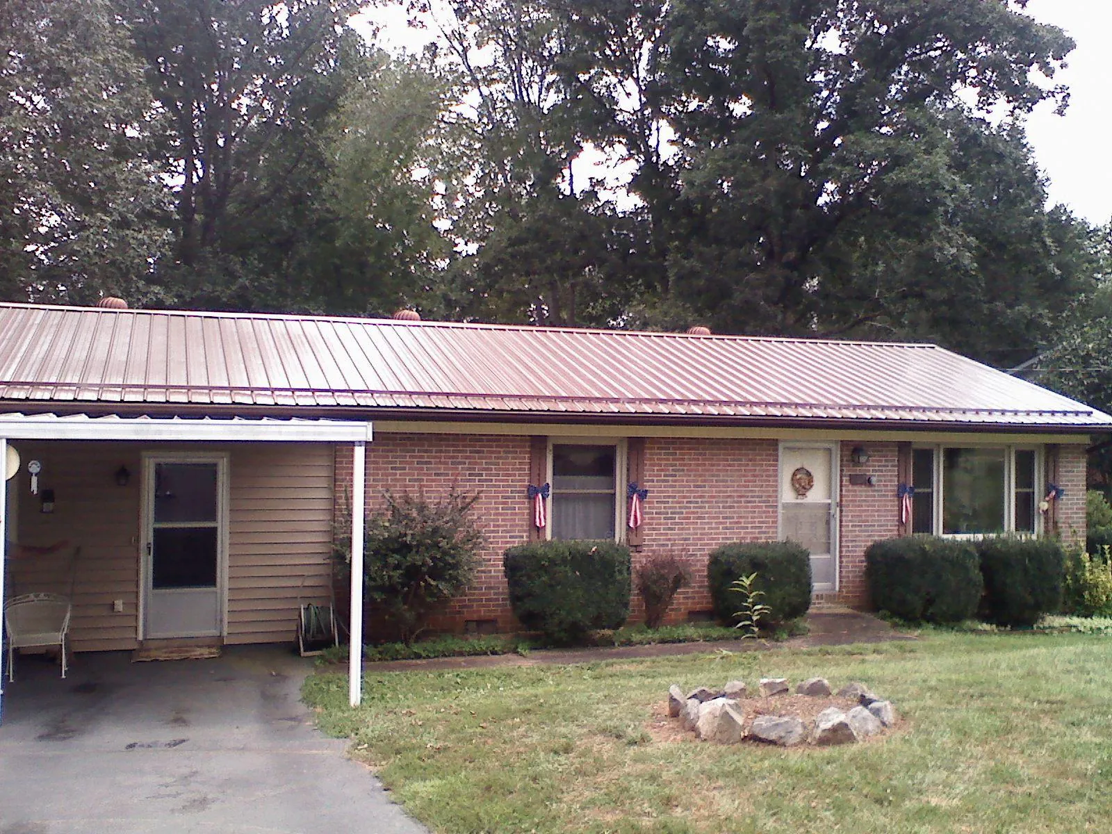 Bronze metal roof and carport on a brick ranch home — Roof Repair work by our crew in Glen Spey